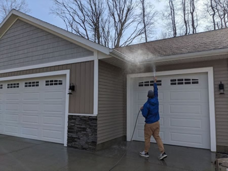 Technician performing gutter brightening on a home in portage mi